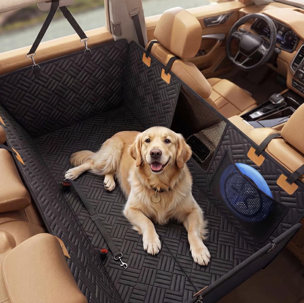 Golden retriever lying on the back seat extender, with the mesh window and storage pocket visible