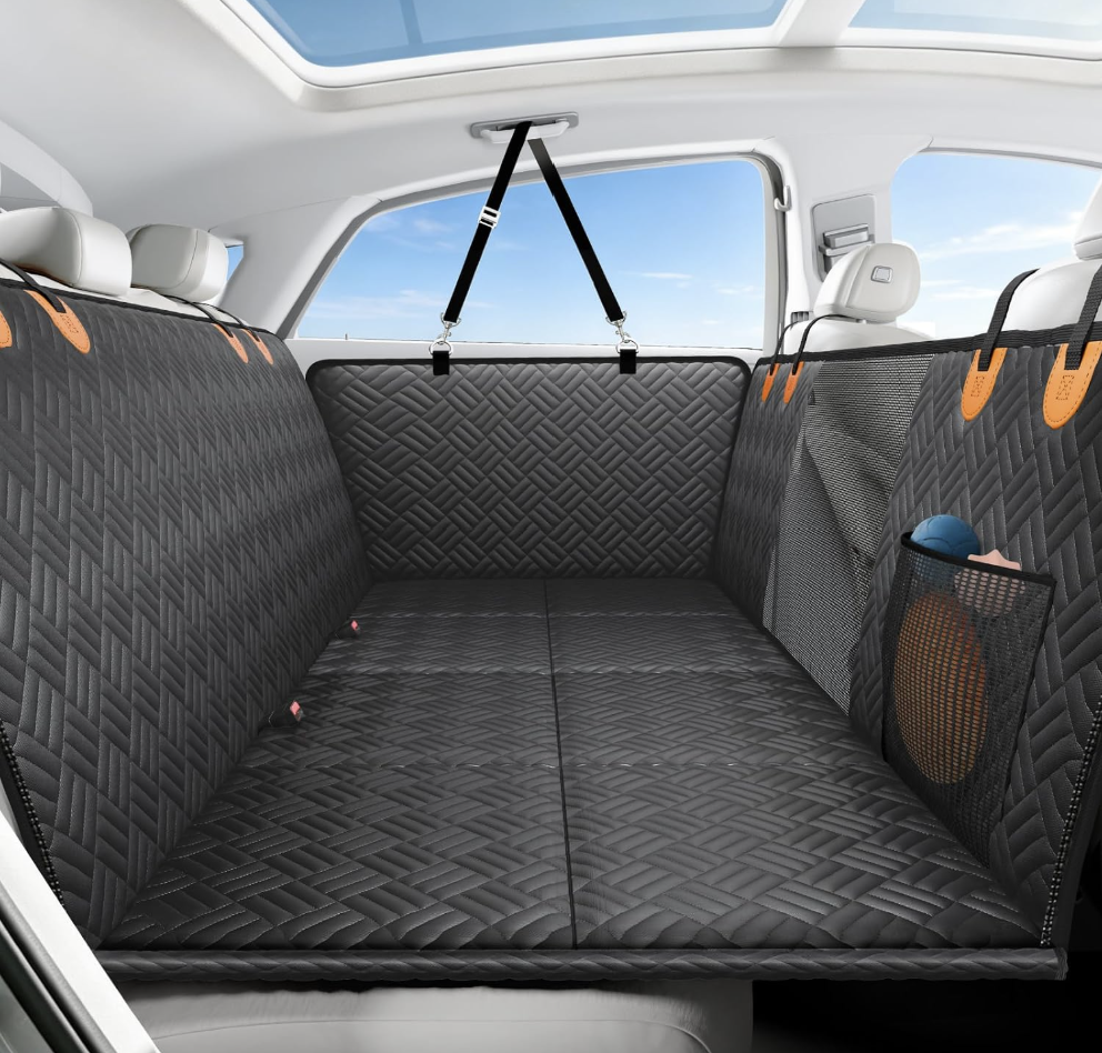Seatbridge back seat extender for dogs in black with orange tabs, installed across a car's back seat
