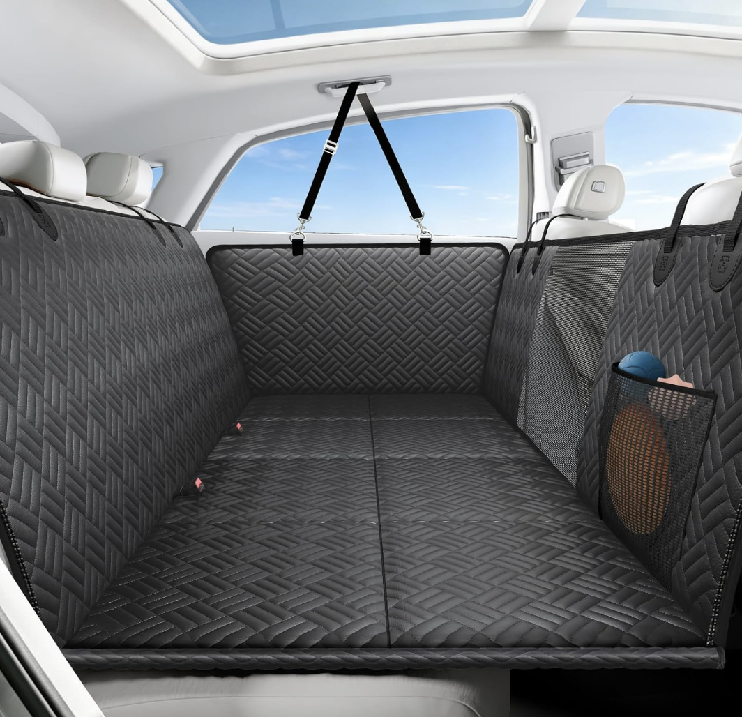 Seatbridge back seat extender for dogs in black/grey, installed across a car's back seat with mesh window and storage pocket