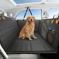 Golden retriever sitting on the Seatbridge back seat extender for dogs, black with orange tabs, installed in a car